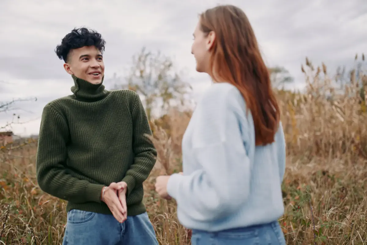 Two people engaging in a calm, casual conversation outdoors, illustrating how supportive friends and family can provide a safe space for open communication during recovery.